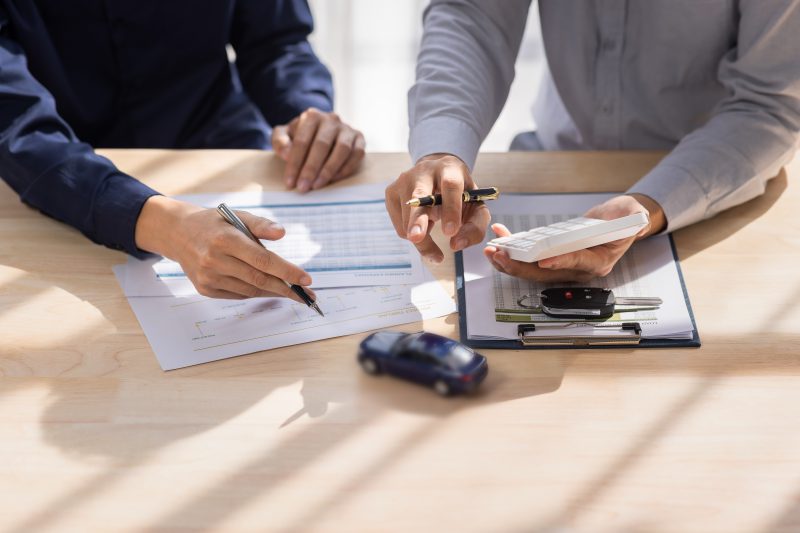 Car Insurance document or lease concept the car broker assisting Car Insurance document or lease concept the car broker assisting
